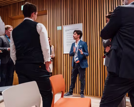 small group of people listening to explanation by inventor