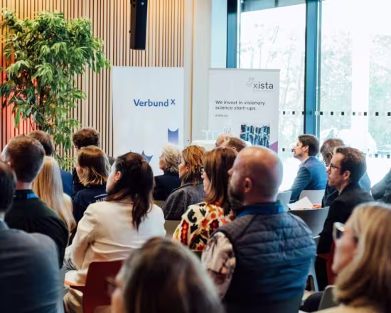 audience at venture day, roll-ups in the background