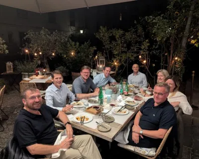the members of the board sitting around a table with food