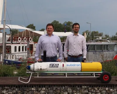 the two founders of Subdron standing behind their drone